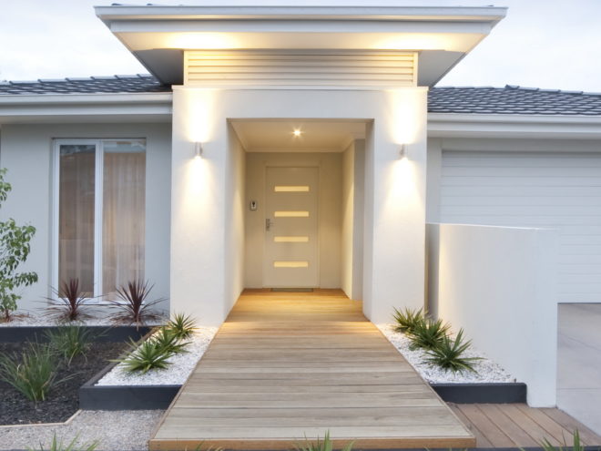 Facade and entry to a contemporary white rendered home in Australia - vertical